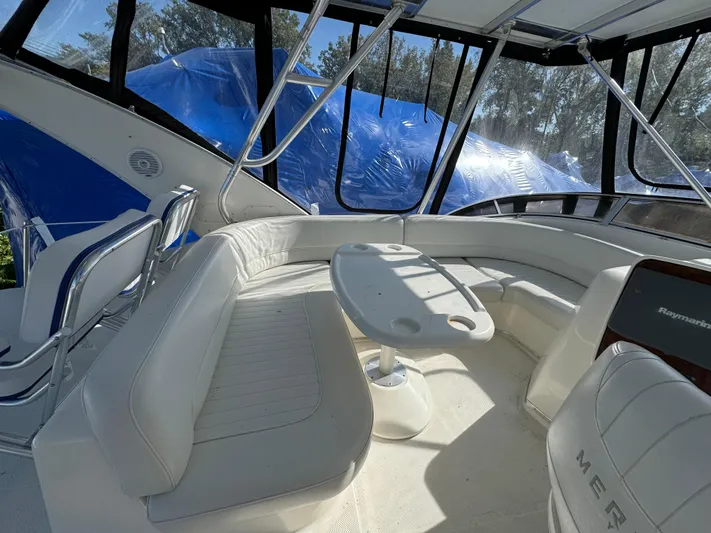 Baby Cake Yacht Photos Pics 2004 Meridian 381 Sedan interior with white seating and table, featuring large windows.