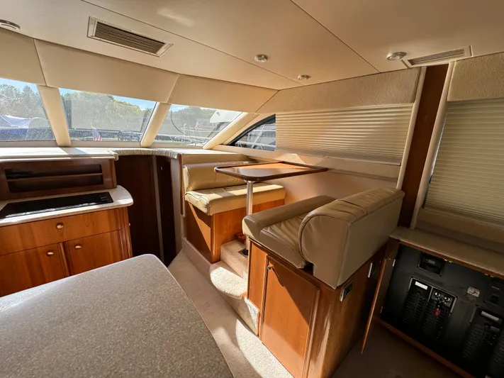 Baby Cake Yacht Photos Pics Interior of a 2004 Meridian 381 Sedan yacht with seating and wooden cabinetry.