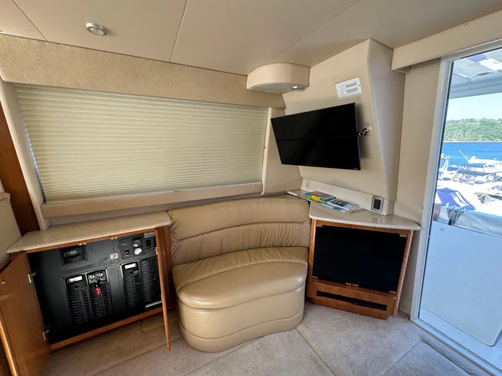 Baby Cake Yacht Photos Pics Interior of 2004 Meridian 381 Sedan yacht with leather seating and mounted TV.