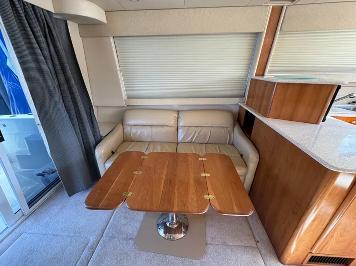 Baby Cake Yacht Photos Pics 2004 Meridian 381 Sedan interior with leather seating and wooden table.
