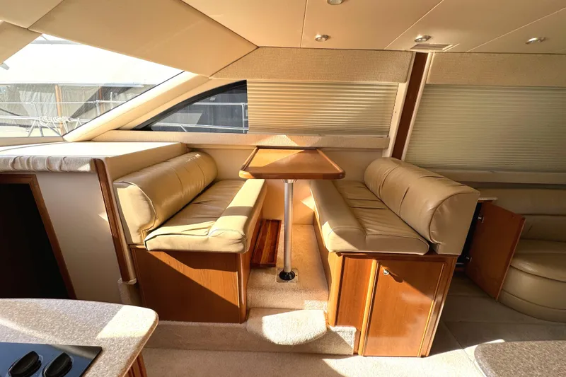 Baby Cake Yacht Photos Pics Luxurious interior of 2004 Meridian 381 Sedan with beige seating and wooden table.