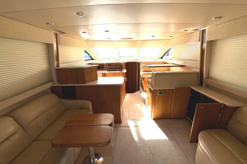 Baby Cake Yacht Photos Pics Luxurious interior of a 2004 Meridian 381 Sedan yacht with leather seating and wood finishes.