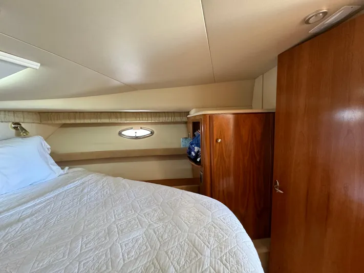 Baby Cake Yacht Photos Pics Luxurious cabin interior of 2004 Meridian 381 Sedan with bed and wooden cabinetry.