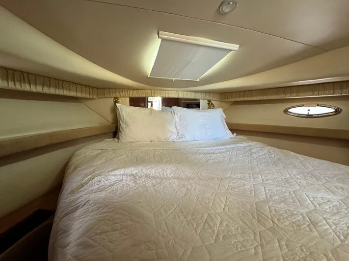 Baby Cake Yacht Photos Pics Luxurious cabin interior of 2004 Meridian 381 Sedan with cozy bed and porthole window.