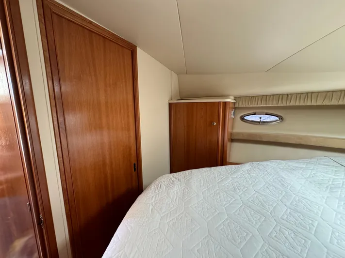 Baby Cake Yacht Photos Pics Interior of 2004 Meridian 381 Sedan with wood paneling and bed.