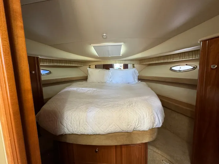 Baby Cake Yacht Photos Pics Luxurious cabin interior of 2004 Meridian 381 Sedan with cozy bed and elegant wood finish.