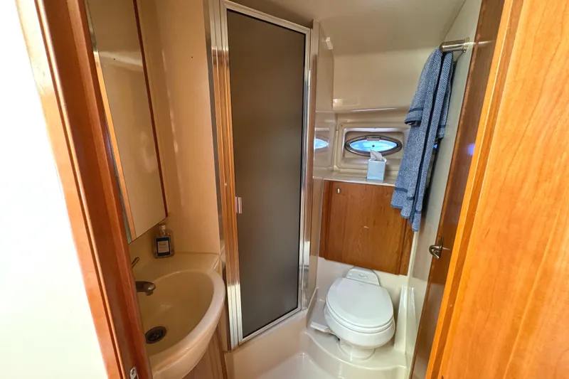 Baby Cake Yacht Photos Pics 2004 Meridian 381 Sedan bathroom with shower, sink, and toilet.