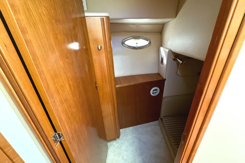 Baby Cake Yacht Photos Pics 2004 Meridian 381 Sedan interior with wood cabinetry and small window.