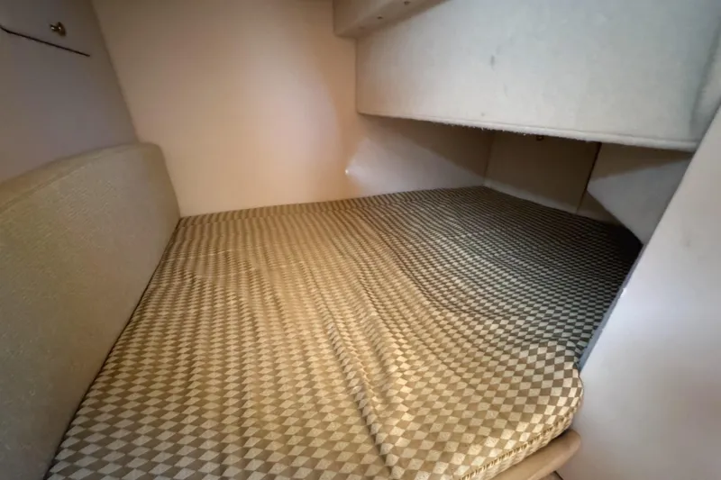 Baby Cake Yacht Photos Pics 2004 Meridian 381 Sedan cabin interior with patterned bed and storage space.