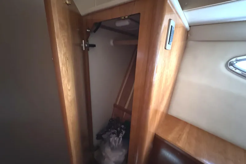Baby Cake Yacht Photos Pics Interior view of a 2004 Meridian 381 Sedan boat closet with wooden finish.