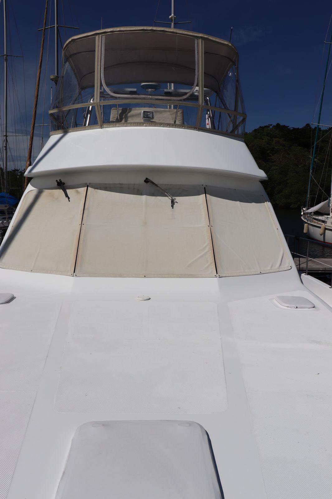 2010 Alpha 50 yacht with covered deck and clear blue sky.