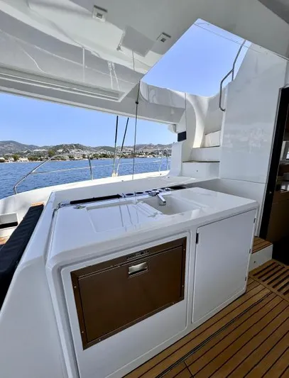  Yacht Photos Pics 2023 Lagoon 55 yacht interior with modern kitchen and ocean view.