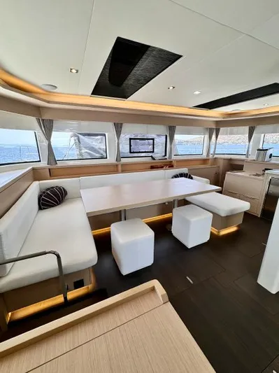  Yacht Photos Pics Luxurious interior of 2023 Lagoon 55 yacht with modern seating and panoramic windows.