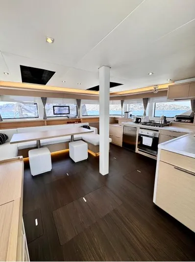  Yacht Photos Pics Luxurious interior of 2023 Lagoon 55 yacht with modern kitchen and seating area.