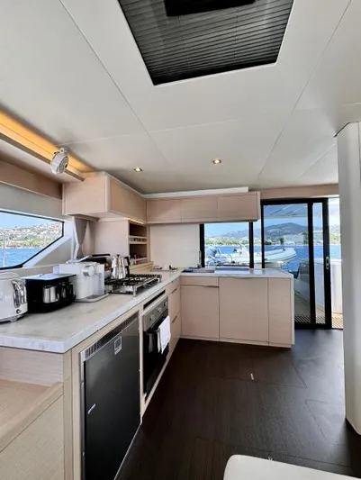  Yacht Photos Pics Modern kitchen interior of 2023 Lagoon 55 yacht with ocean view.