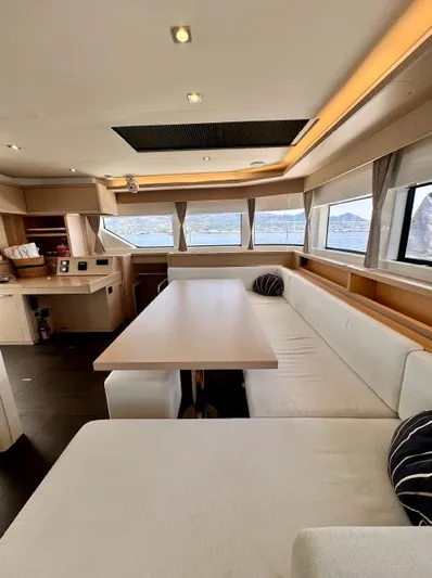  Yacht Photos Pics Luxurious interior of 2023 Lagoon 55 yacht with spacious seating and panoramic windows.