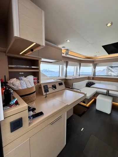  Yacht Photos Pics Modern interior of 2023 Lagoon 55 yacht with sleek kitchen and panoramic windows.