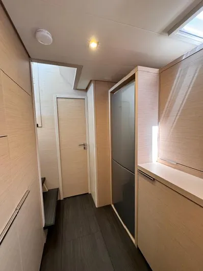  Yacht Photos Pics Modern interior of 2023 Lagoon 55 yacht with sleek cabinetry and minimalist design.