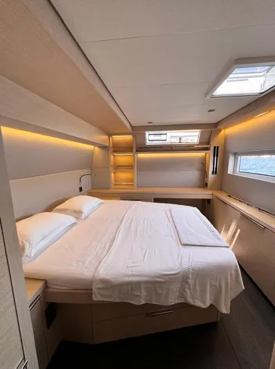  Yacht Photos Pics Luxurious cabin interior of 2023 Lagoon 55 yacht with modern design and ambient lighting.