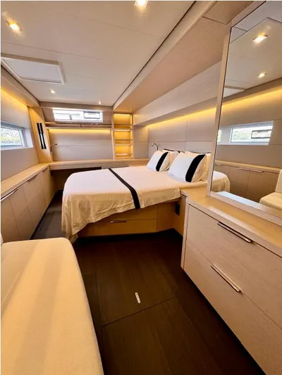  Yacht Photos Pics Luxurious bedroom interior of 2023 Lagoon 55 yacht with modern design and ambient lighting.