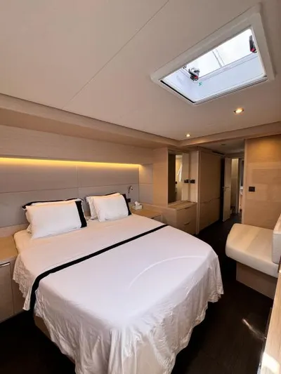  Yacht Photos Pics Luxurious bedroom interior of 2023 Lagoon 55 yacht with skylight and modern design.
