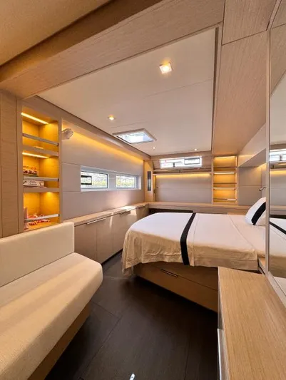  Yacht Photos Pics Luxurious interior of 2023 Lagoon 55 yacht with modern bedroom design and ambient lighting.