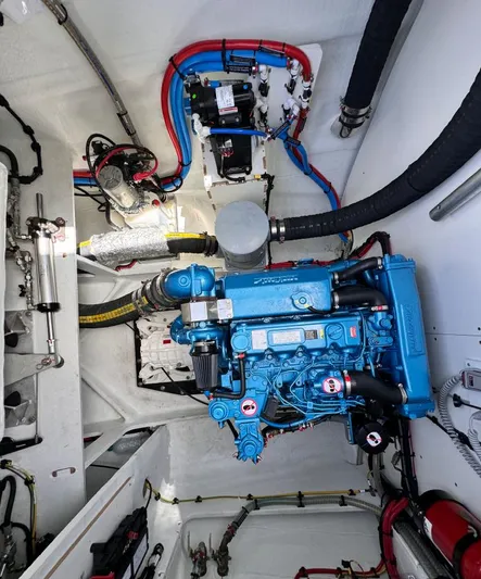  Yacht Photos Pics Engine room of 2023 Lagoon 55 yacht with blue engine and organized wiring.