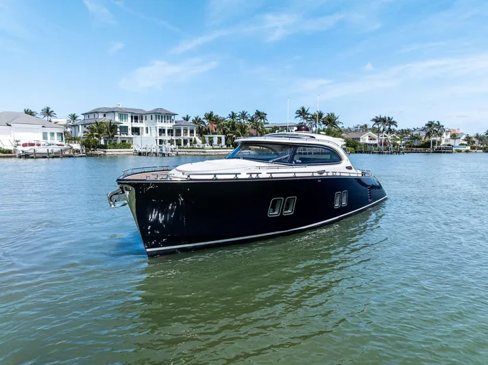 A. Noochette Yacht Photos Pics 2024 Zeelander Z5 yacht cruising on a sunny day near luxury waterfront homes.
