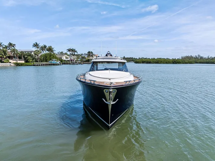 A. Noochette Yacht Photos Pics 2024 Zeelander Z5 yacht on calm water, surrounded by lush greenery and clear skies.