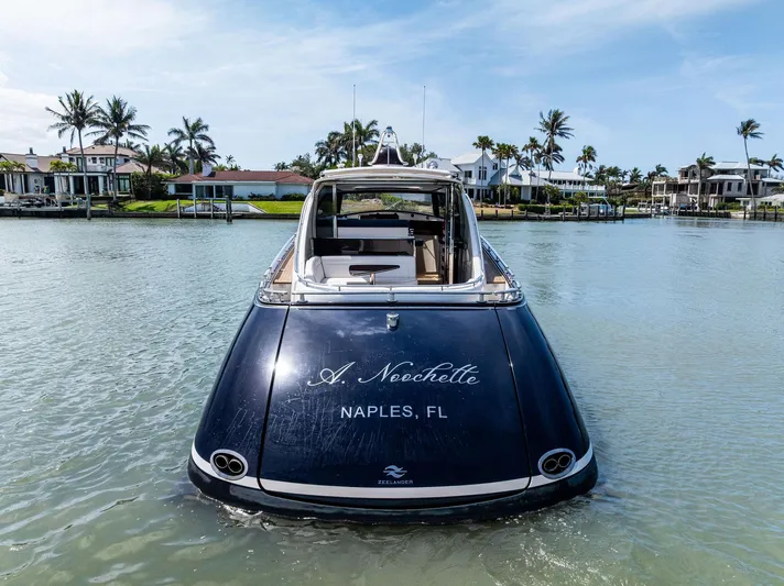 A. Noochette Yacht Photos Pics 2024 Zeelander Z5 yacht in Naples, FL, on calm water with palm trees.