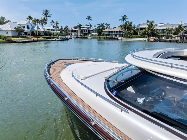 A. Noochette Yacht Photos Pics 2024 Zeelander Z5 yacht cruising in a scenic waterfront area with palm trees and luxury homes.