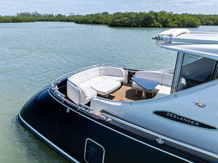 A. Noochette Yacht Photos Pics 2024 Zeelander Z5 yacht with elegant seating area on calm water.