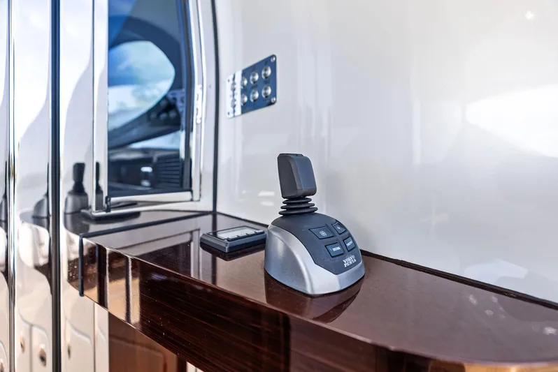 A. Noochette Yacht Photos Pics 2024 Zeelander Z5 yacht control panel with joystick on polished wooden surface.