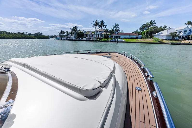 A. Noochette Yacht Photos Pics 2024 Zeelander Z5 yacht deck with scenic waterfront view and palm trees.