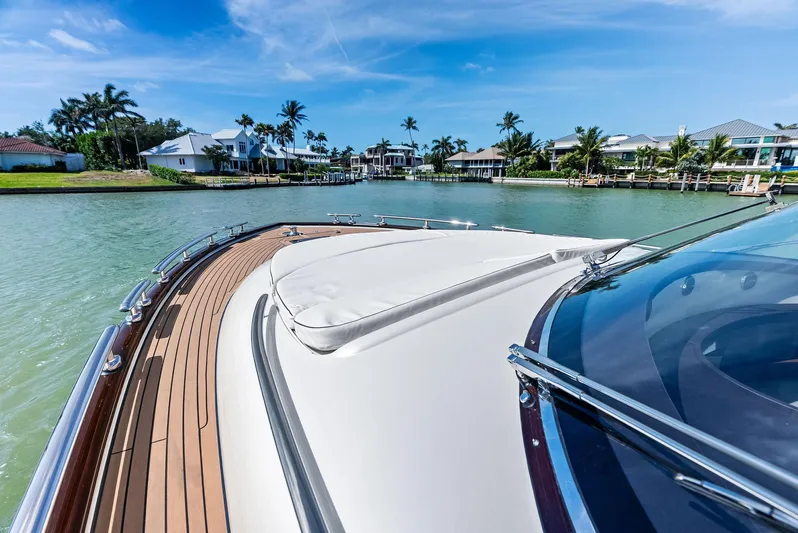 A. Noochette Yacht Photos Pics 2024 Zeelander Z5 yacht cruising in a scenic waterfront setting with palm trees.