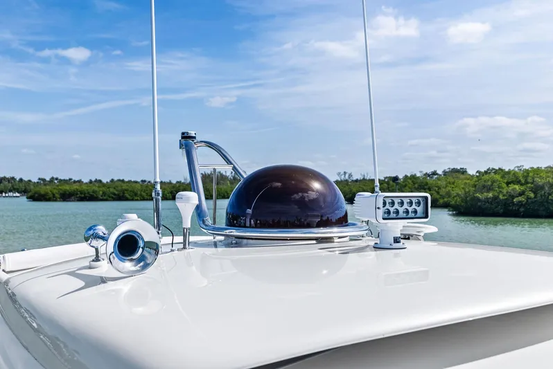 A. Noochette Yacht Photos Pics 2024 Zeelander Z5 yacht deck with radar and antennas, set against a serene water backdrop.