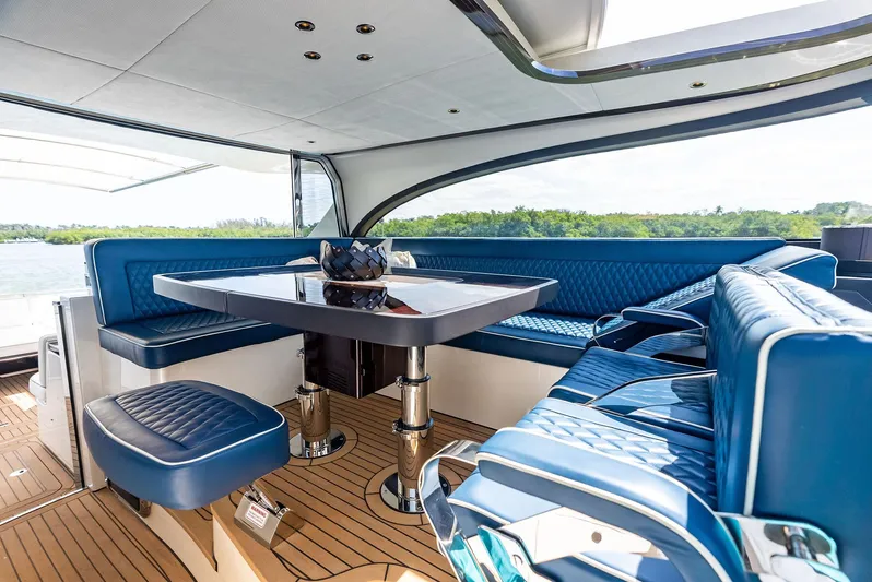A. Noochette Yacht Photos Pics Luxurious interior of 2024 Zeelander Z5 yacht with blue seating and elegant table.