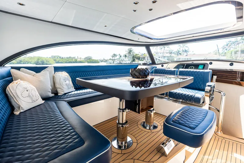A. Noochette Yacht Photos Pics Luxurious interior of 2024 Zeelander Z5 yacht with blue seating and elegant table.