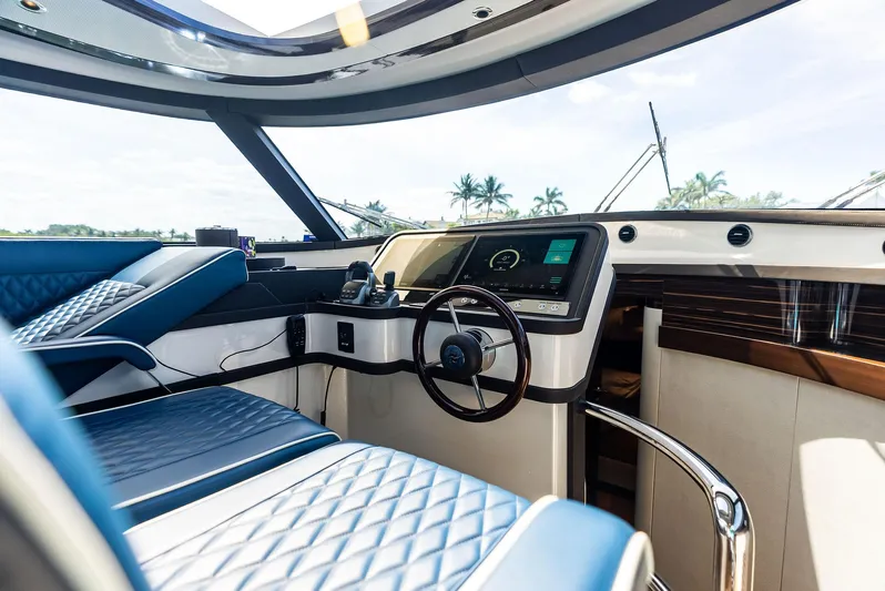 A. Noochette Yacht Photos Pics Luxurious 2024 Zeelander Z5 yacht interior with modern steering and blue quilted seating.