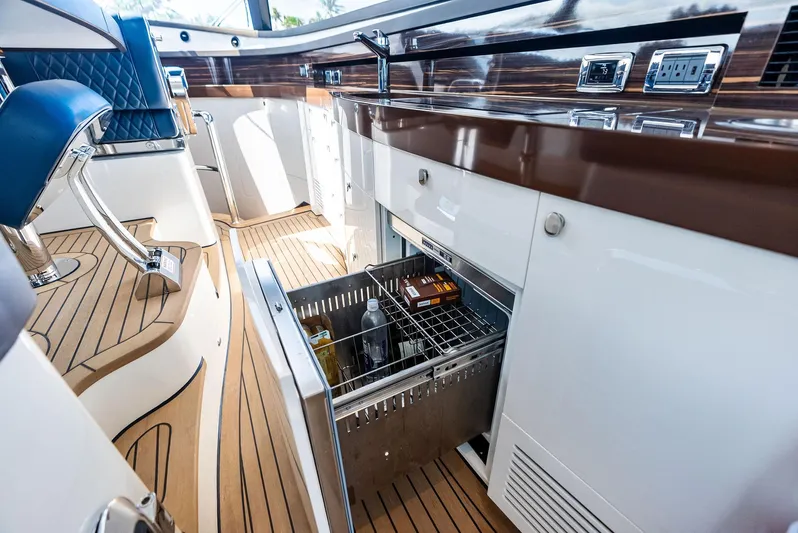 A. Noochette Yacht Photos Pics 2024 Zeelander Z5 yacht interior with open drawer fridge, sleek design, and wooden flooring.