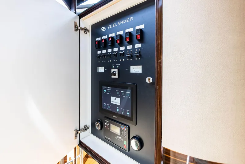 A. Noochette Yacht Photos Pics Electrical control panel inside 2024 Zeelander Z5 yacht, featuring switches and display.