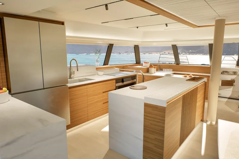 Hull #2 Fpy 70 - Coming End 2026 Yacht Photos Pics Luxurious kitchen interior of 2027 Fountaine Pajot FPY 70 yacht with ocean view.
