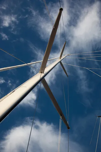 Bamboozle Yacht Photos Pics Mast of 2010 Spirit Yachts Spirit 46 sailboat against a blue sky with clouds.