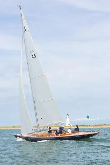 Bamboozle Yacht Photos Pics Sailing yacht Spirit 46, 2010 model, cruising near a lighthouse on a sunny day.
