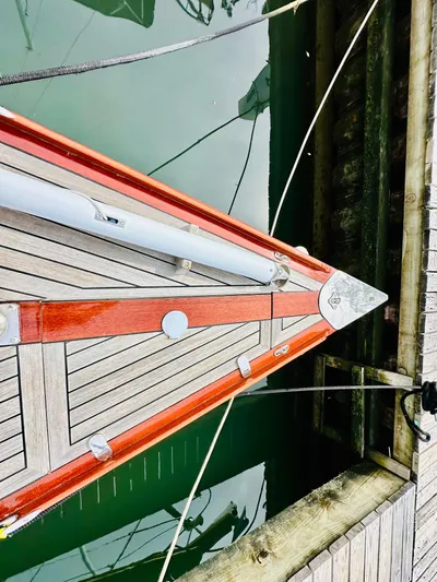 Bamboozle Yacht Photos Pics Bow of 2010 Spirit Yachts Spirit 46, docked with wooden deck and green water.