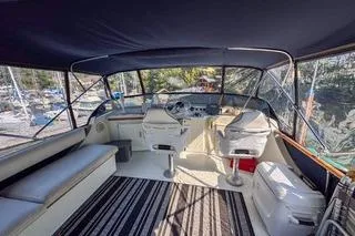 Rose Petal Yacht Photos Pics 1981 Tollycraft 48 Cockpit Motor Yacht interior with seating and helm, under canopy.