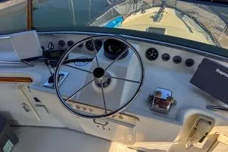 Rose Petal Yacht Photos Pics Cockpit view of 1981 Tollycraft 48 Cockpit Motor Yacht with steering wheel and controls.