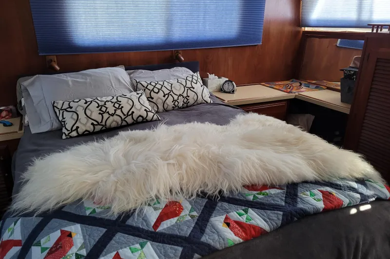 Rose Petal Yacht Photos Pics Cozy bedroom in 1981 Tollycraft 48 Cockpit Motor Yacht with plush bedding and decorative pillows.