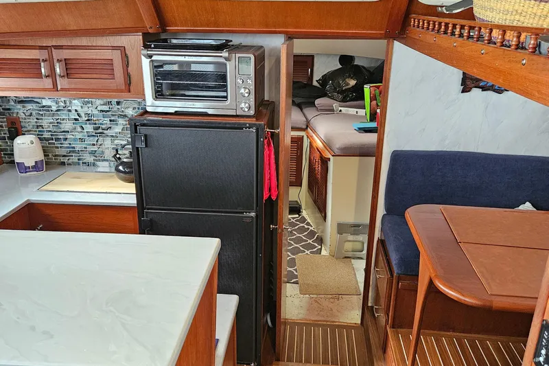 Rose Petal Yacht Photos Pics 1981 Tollycraft 48 Cockpit Motor Yacht interior with kitchen, dining area, and cozy sleeping quarters.