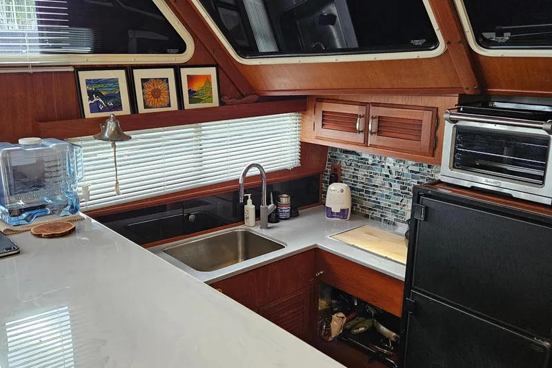 Rose Petal Yacht Photos Pics 1981 Tollycraft 48 Cockpit Motor Yacht kitchen with modern appliances and wood cabinetry.
